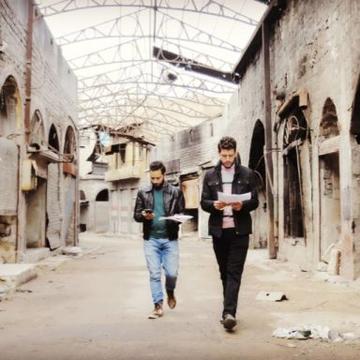 Two young architects in the ruined souk in Homs - Source Abdullah Al-Jundi 
