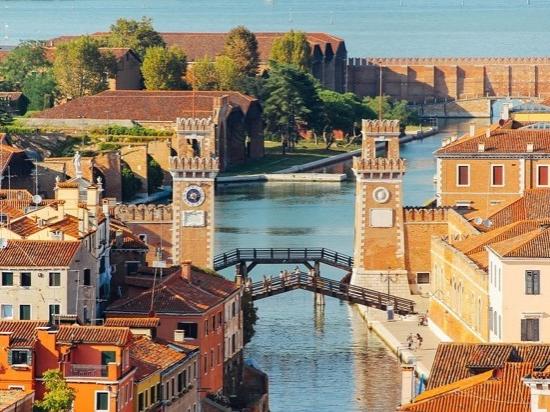 River with old buildings either side and two bridges crossing it